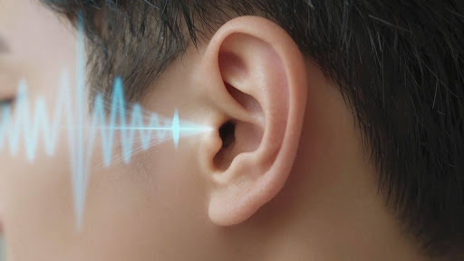 Ear with sound waves emanating from it.